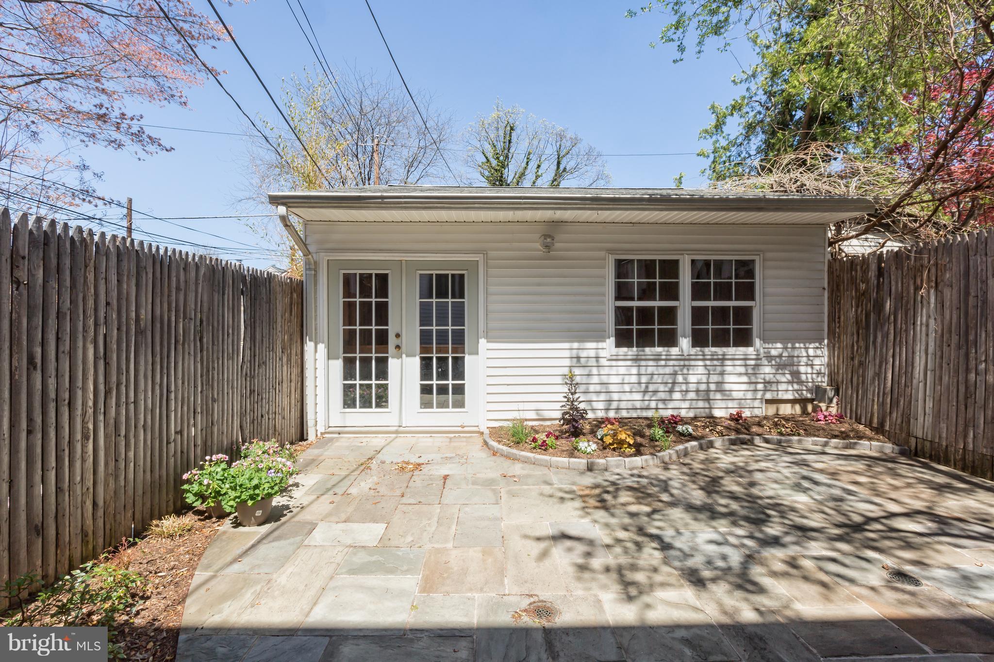 3535 R Street Northwest Washington, DC 20007 - Photo 27 of 29 a front view of a house with a large window and potted plants