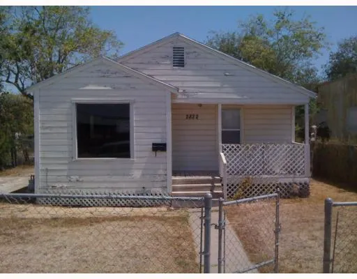 a front view of a house with garage and yard