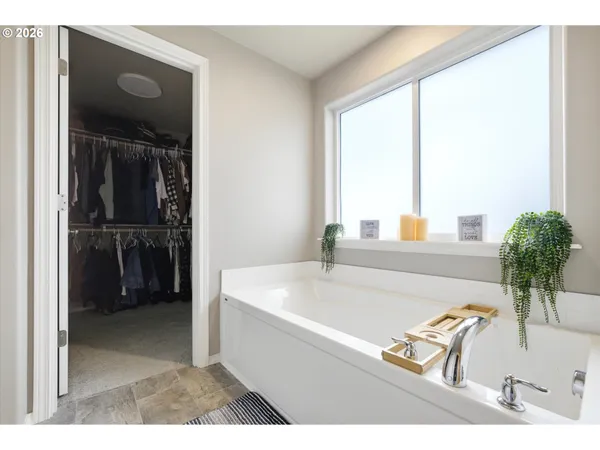 a bathroom with a tub sink and a mirror