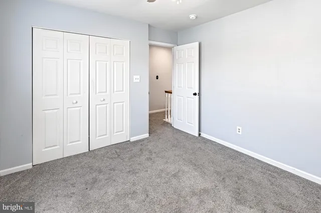 an empty room with closet area