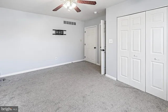 an empty room with a ceiling fan