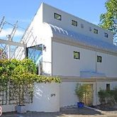 a front view of a house with plants