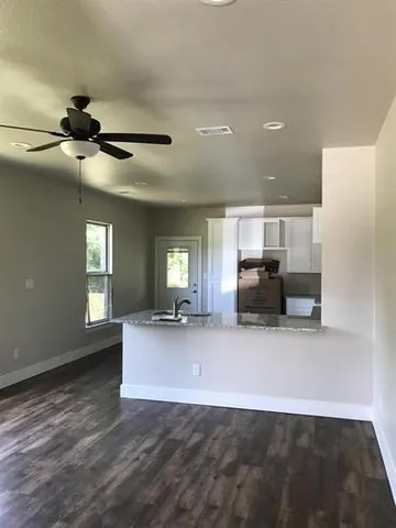 a view of a kitchen with furniture and a ceiling fan