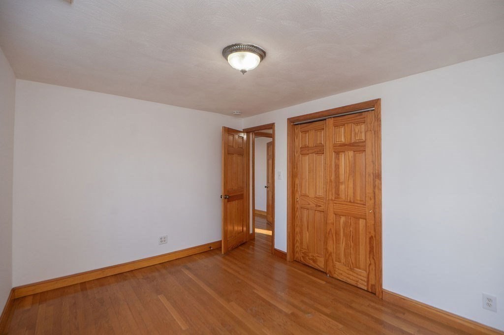 3 Pershing Road Salem, MA 01970 - Photo 20 of 38 a view of an empty room with wooden floor and closet