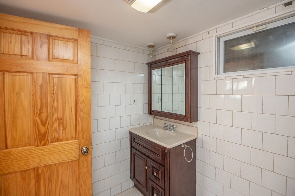 3 Pershing Road Salem, MA 01970 - Photo 30 of 38 a bathroom with a sink a mirror and a shower