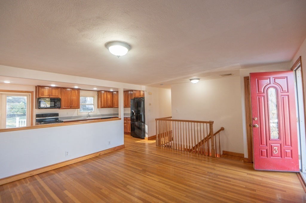 3 Pershing Road Salem, MA 01970 - Photo 5 of 38 an empty room with wooden floor and windows