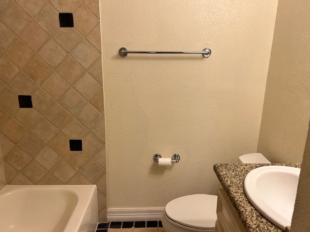 4401 Marina Street, Unit B Houston, TX 77007 - Photo 15 of 26 a white toilet and tub sitting next to a bathroom sink