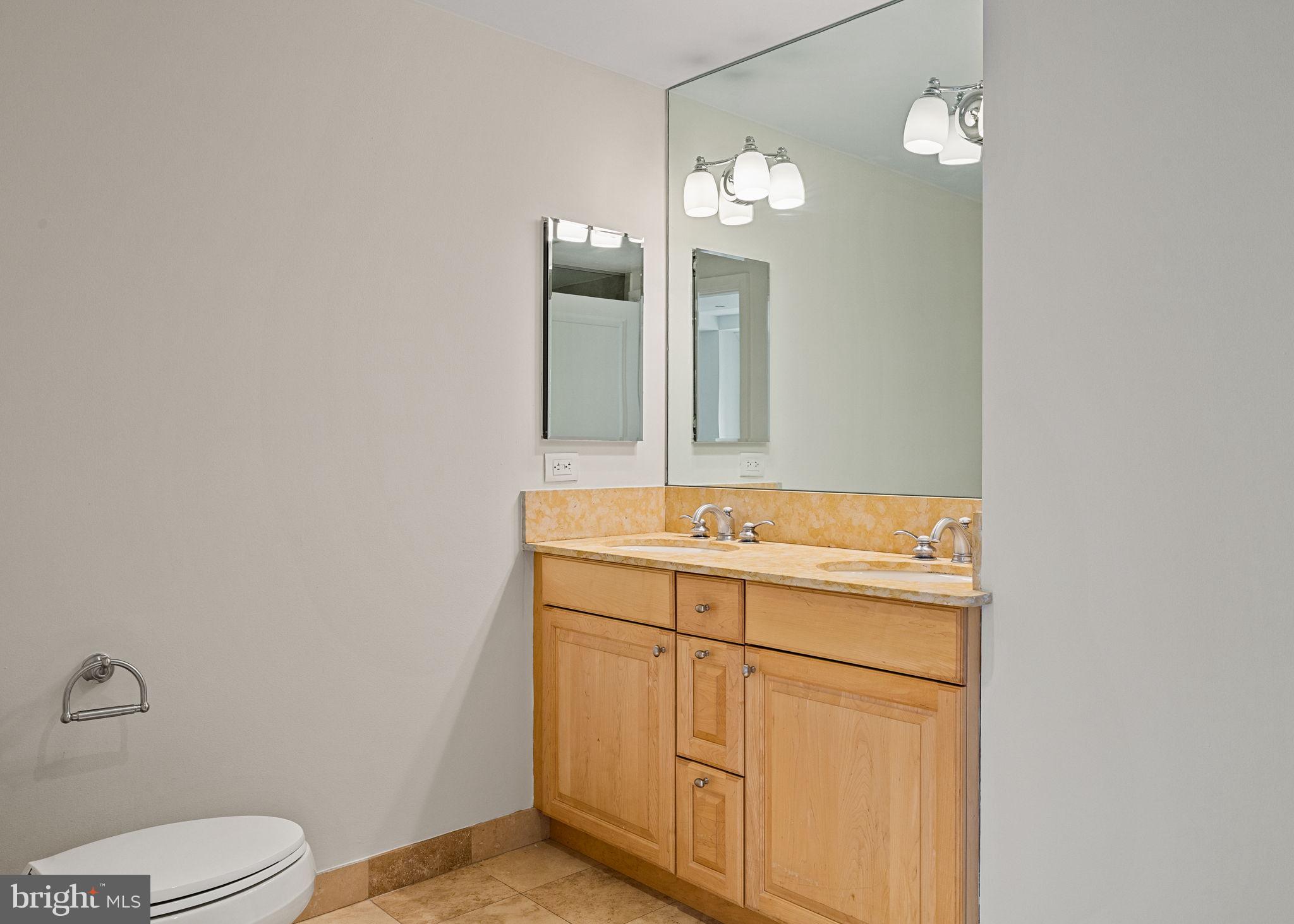 1701 Locust Street, Unit 1602 Philadelphia, PA 19103 - Photo 17 of 28 a bathroom with a sink a toilet and mirror