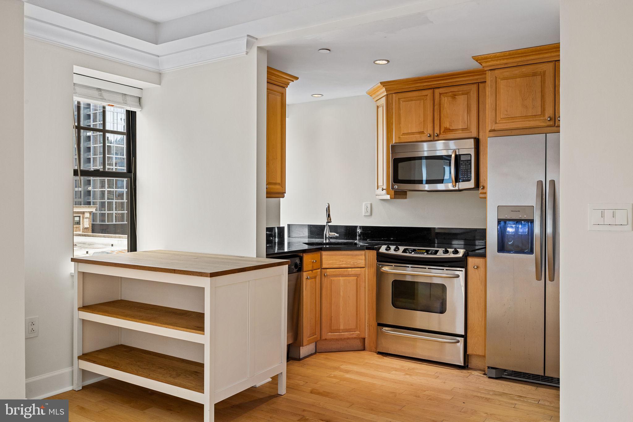 1701 Locust Street, Unit 1602 Philadelphia, PA 19103 - Photo 7 of 28 a kitchen with a stove and a microwave