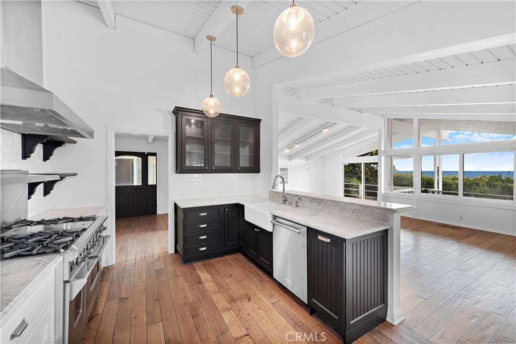 707 Emerald Bay Laguna Beach, CA 92651 - Photo 8 of 50 a kitchen with stainless steel appliances granite countertop a stove and a sink