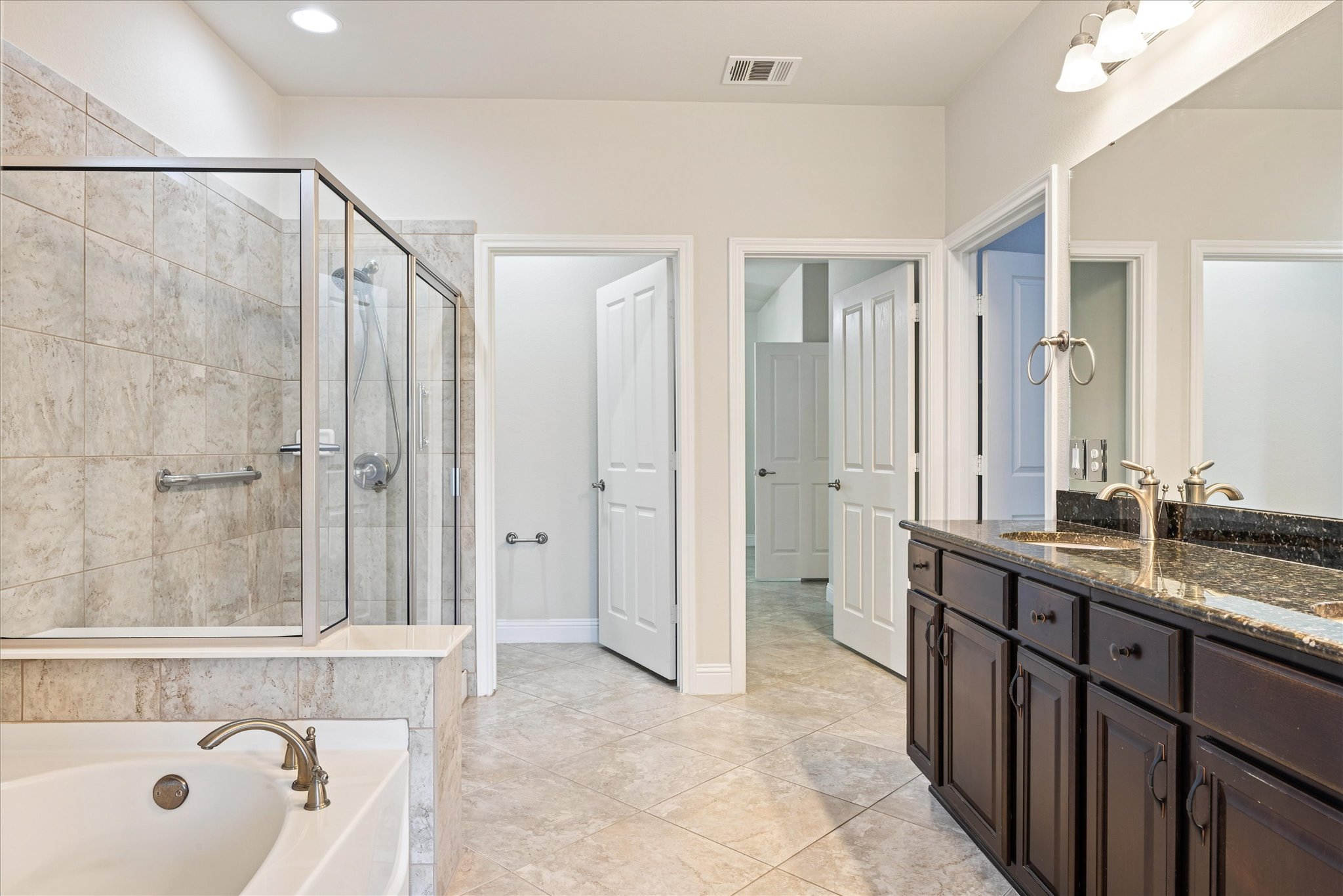 103 McKittrick Ridge Road Georgetown, TX 78633 - Photo 11 of 23 Gleaming stone counters and tiled floors define this well-appointed washroom space.