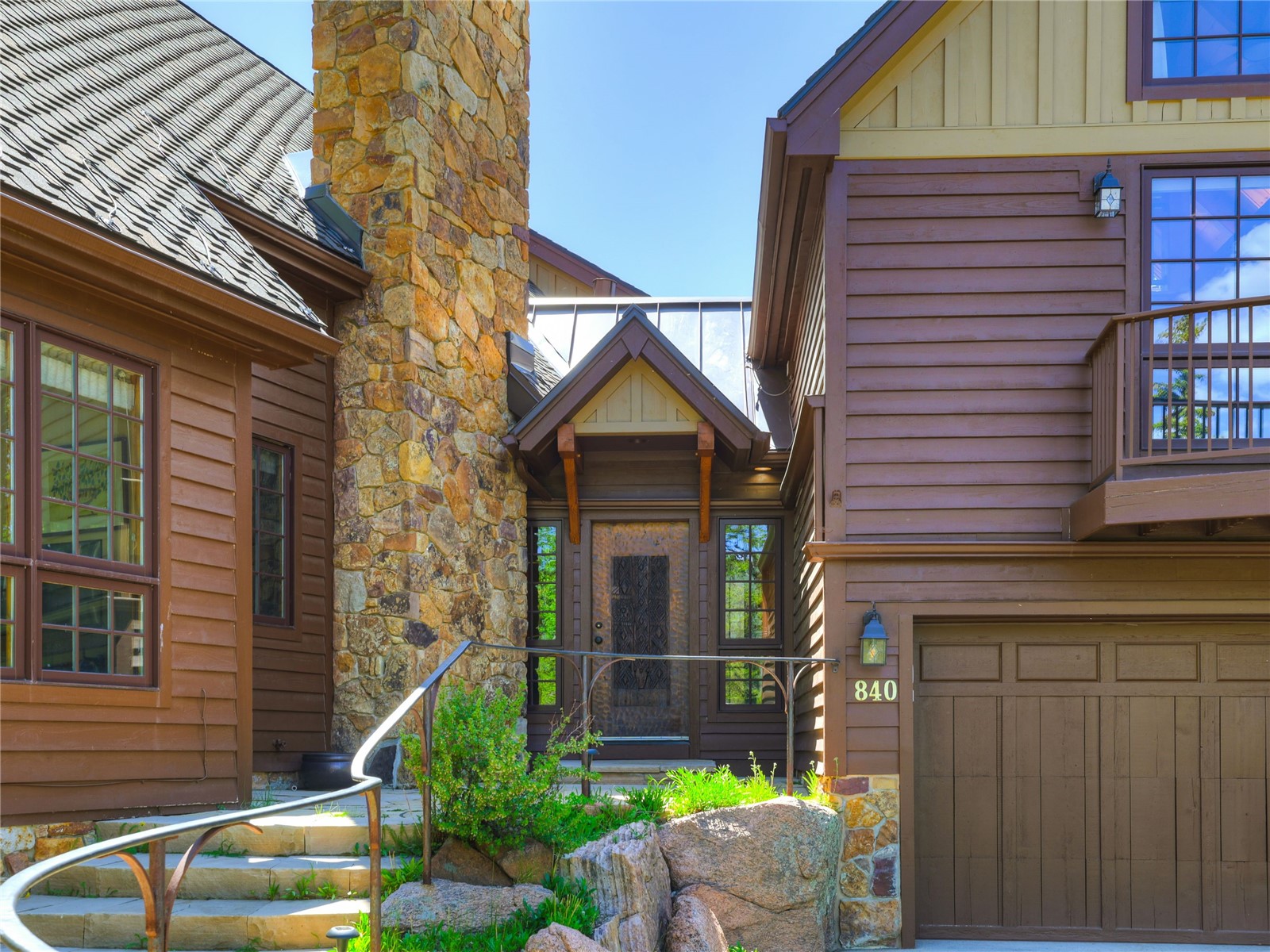 840 Penstemon Road Keystone, CO 80435 - Photo 42 of 50 Doorway to property featuring a chimney, an attached garage, and board and batten siding