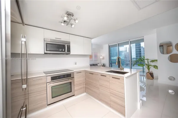 a kitchen with a stove a sink and a microwave