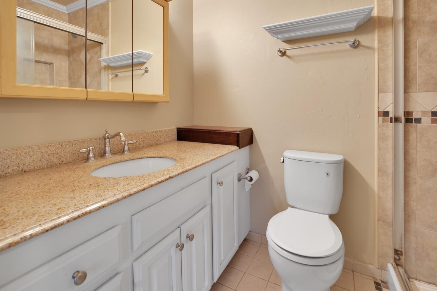 210 Hames Road Corralitos, CA 95076 - Photo 14 of 17 a bathroom with a granite countertop toilet sink and mirror