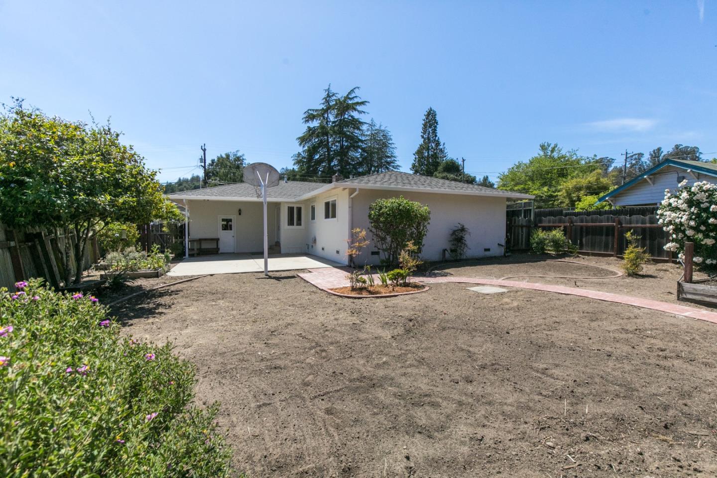 210 Hames Road Corralitos, CA 95076 - Photo 4 of 17 a view of a house with backyard and a garden