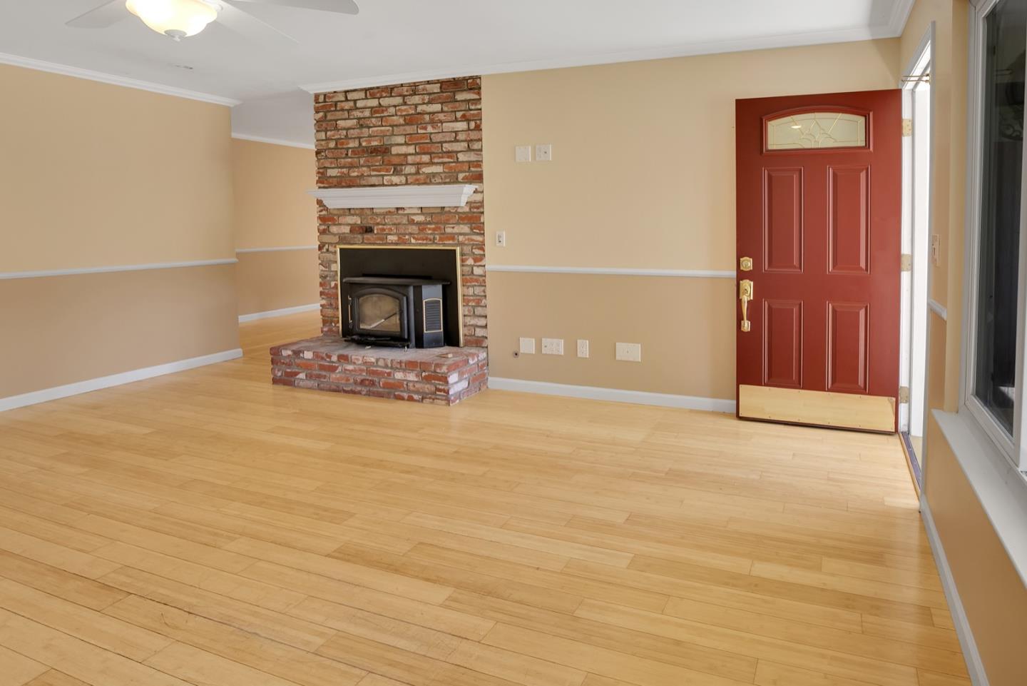 210 Hames Road Corralitos, CA 95076 - Photo 7 of 17 a view of an empty room with wooden floor and a fireplace