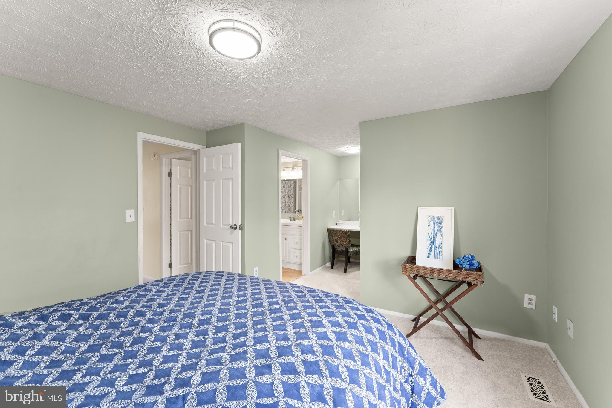 1616 Barnstead Drive Reston, VA 20194 - Photo 27 of 49 a bedroom with a bed and a table