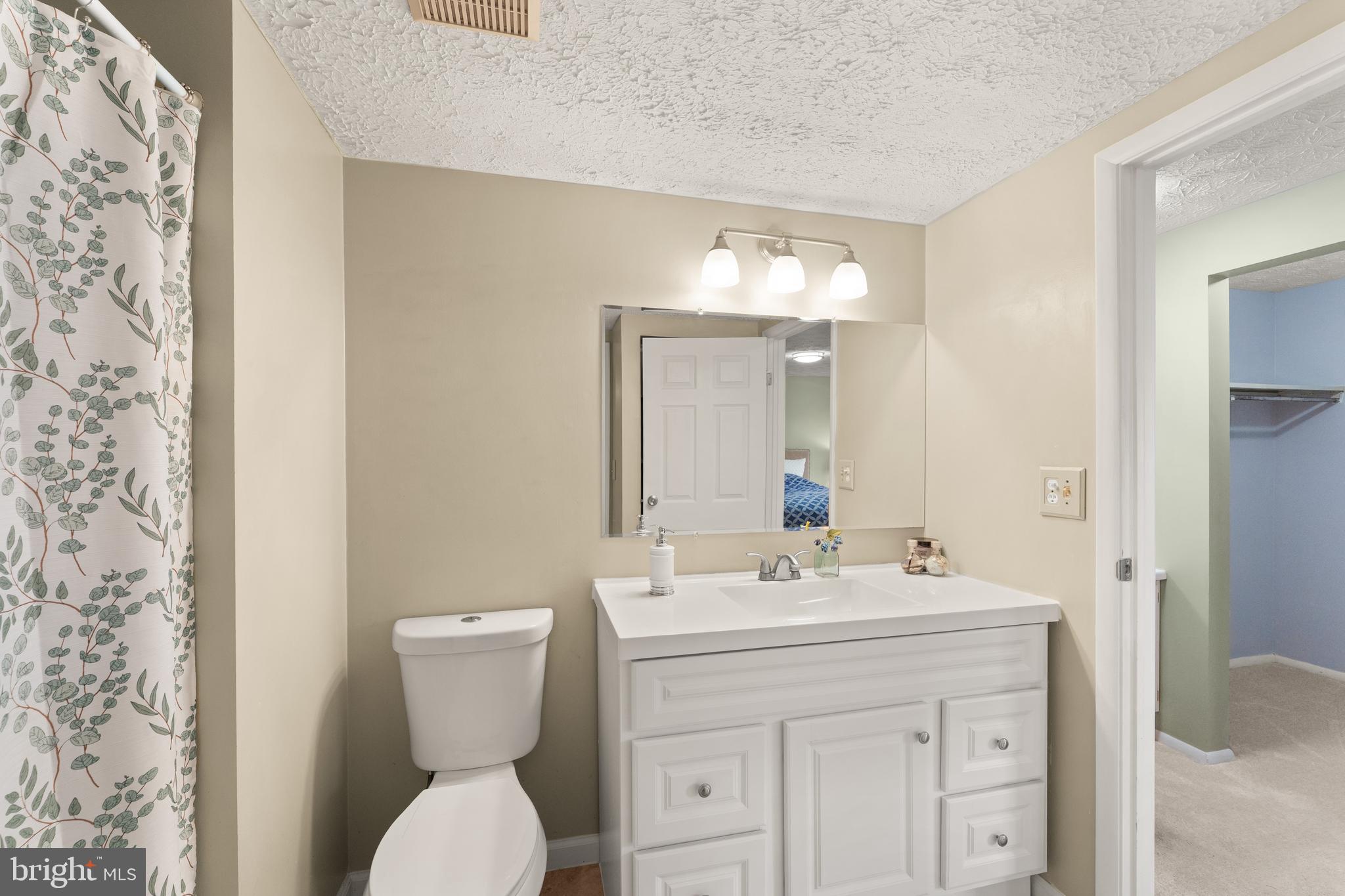 1616 Barnstead Drive Reston, VA 20194 - Photo 30 of 49 a bathroom with a toilet sink and mirror
