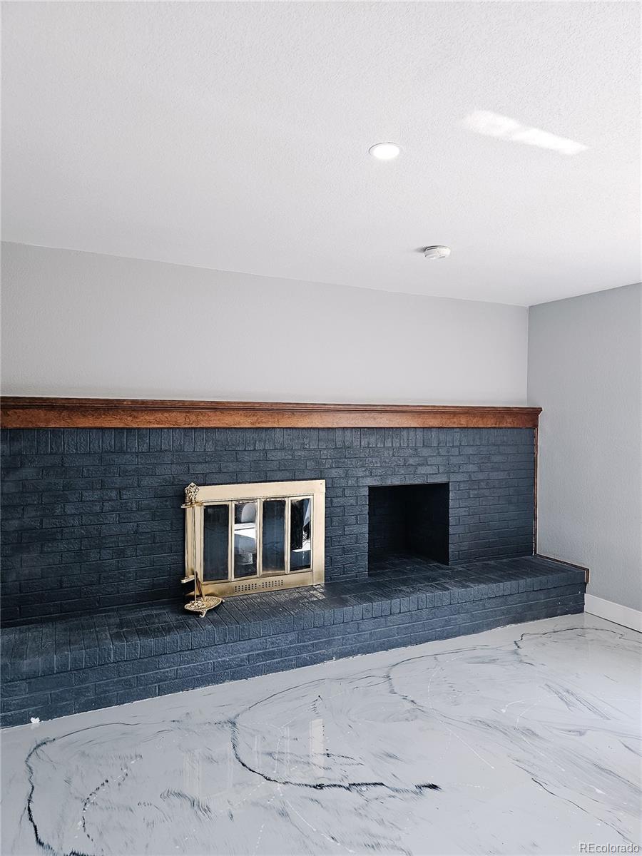 4716 Freeport Way Denver, CO 80239 - Photo 20 of 29 an empty room with a fireplace