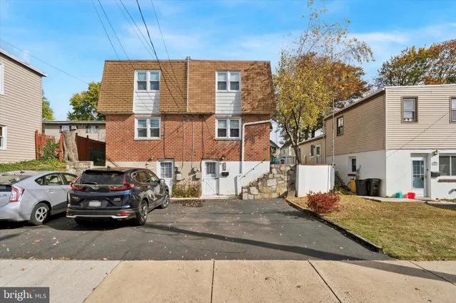a view of a car parked in front of a house