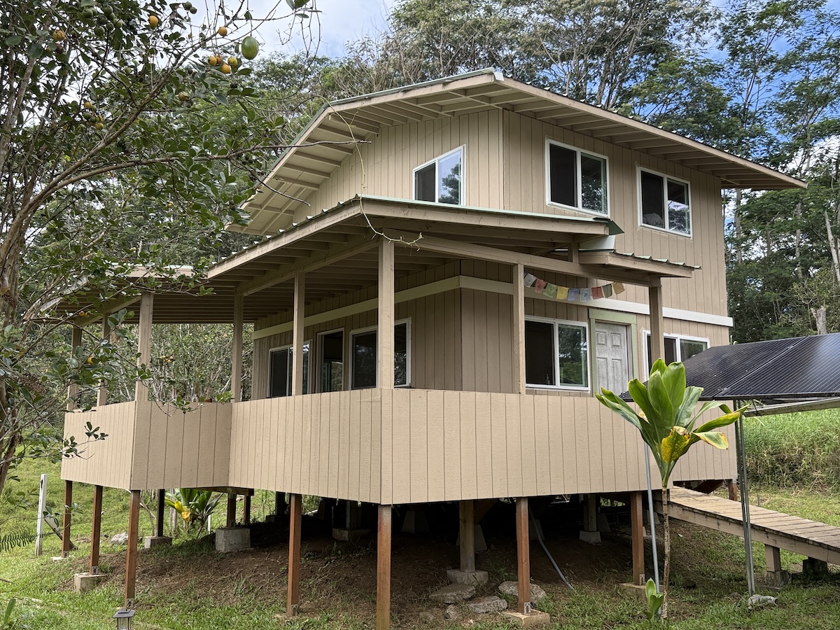 a view of a house with a yard and furniture