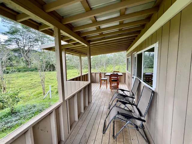 a view of a porch with furniture and wooden floor