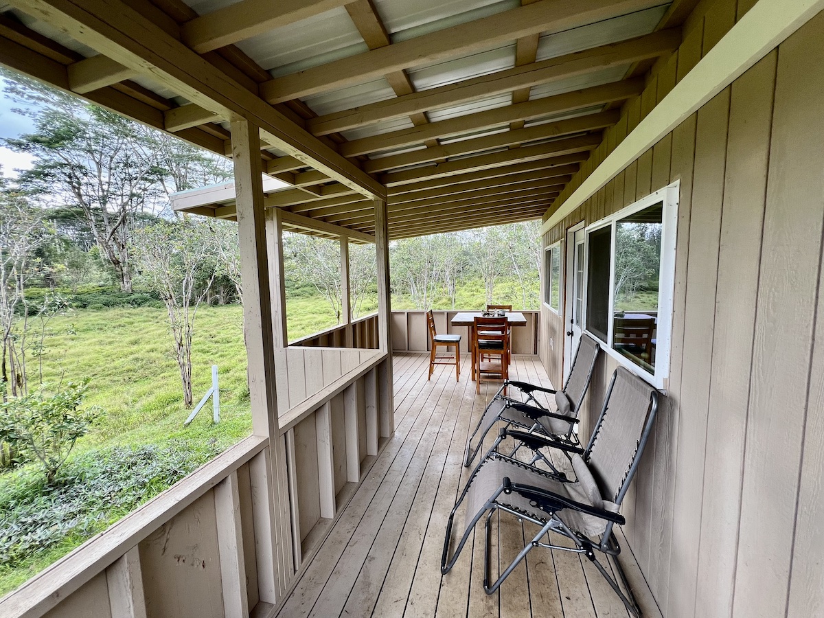 17-3853 Enos Road Mountain View, HI 96760 - Photo 4 of 20 a view of a porch with furniture and wooden floor