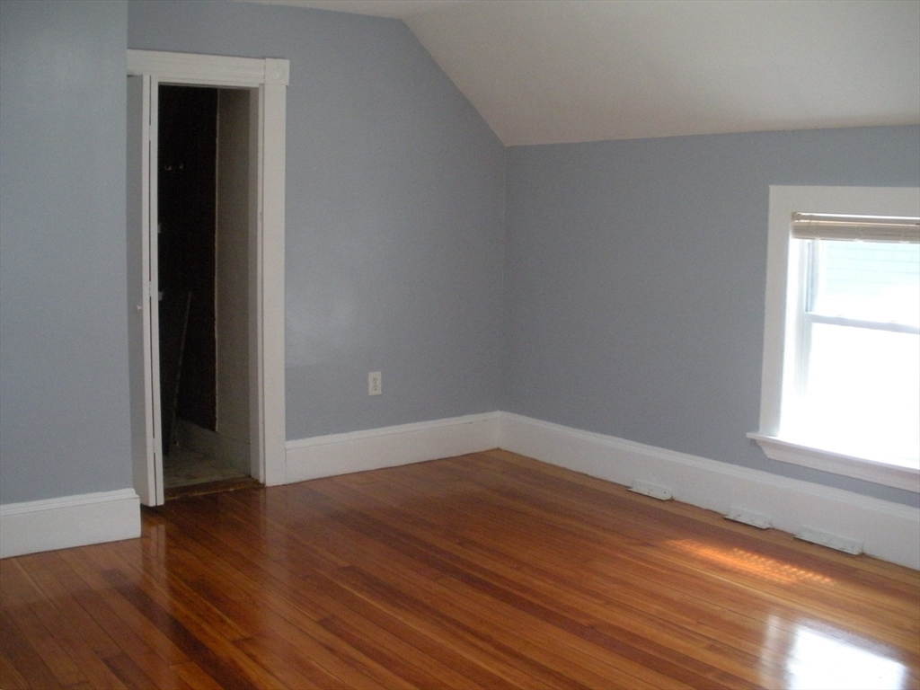 113 Rockland Street, Unit 2 Canton, MA 02021 - Photo 10 of 22 an empty room with wooden floor and windows