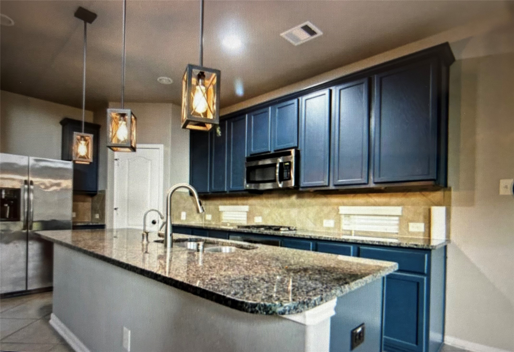 7936 Lake Commons Drive Rosenberg, TX 77469 - Photo 15 of 33 a kitchen with kitchen island granite countertop a sink cabinets and window