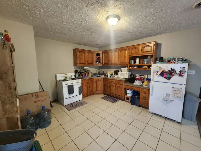 a kitchen with stainless steel appliances a stove top oven a sink a counter space and cabinets