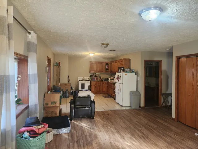 a view of a kitchen and dining room with furniture wooden floor and a chandelier