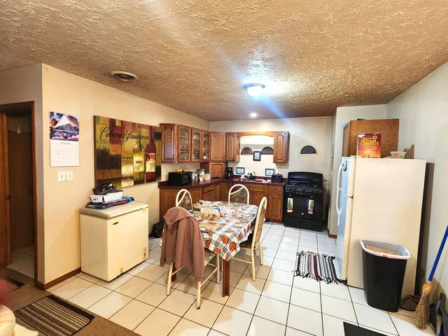 a kitchen with granite countertop cabinets and refrigerator