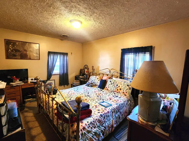 a bed room with a bed and a lamp