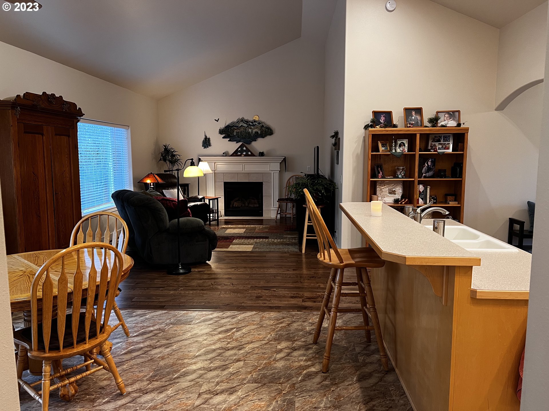947 67th Place Springfield, OR 97478 - Photo 12 of 32 a living room with furniture a fireplace and a flat screen tv