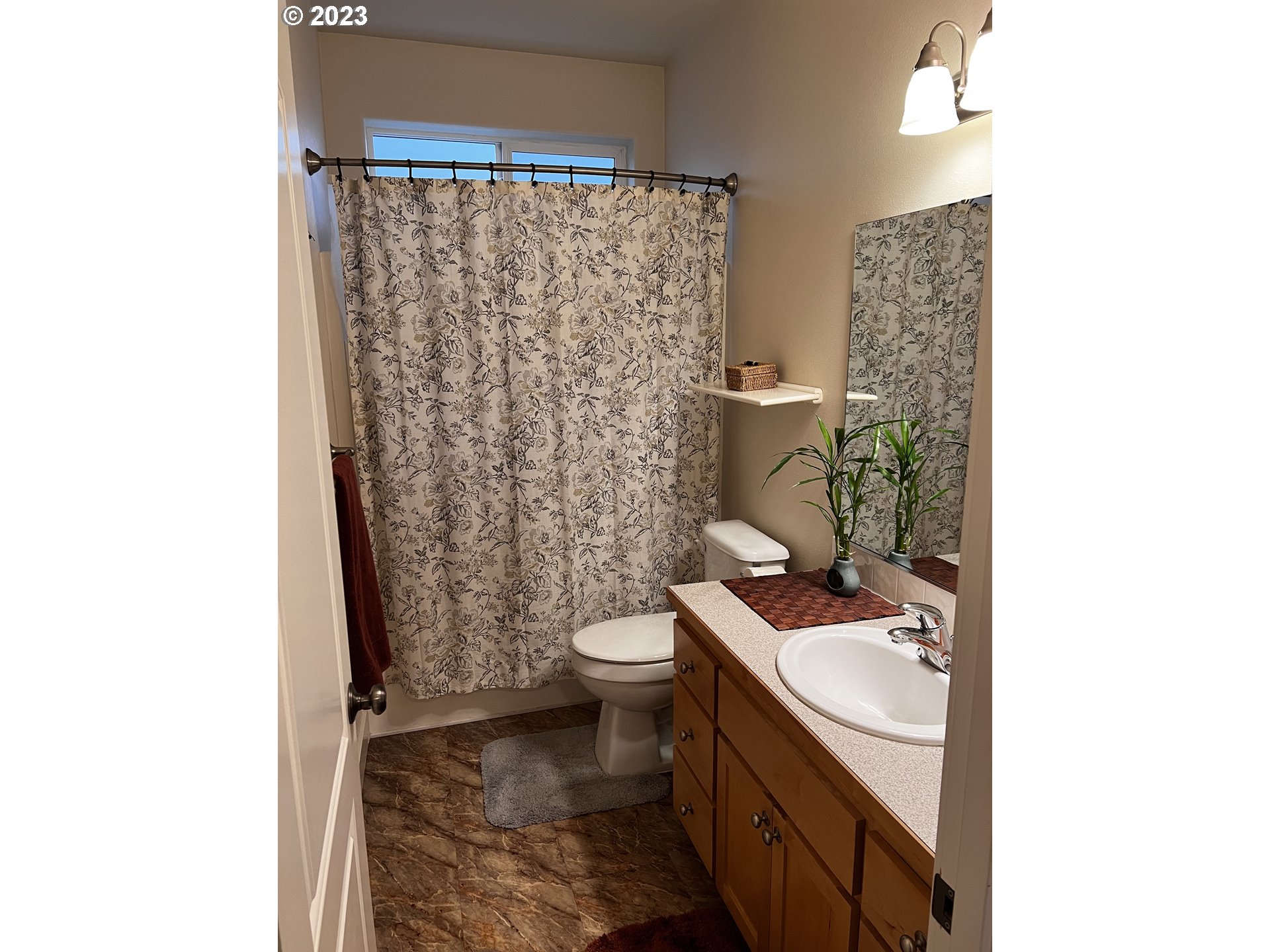 947 67th Place Springfield, OR 97478 - Photo 20 of 32 a bathroom with a sink a toilet and shower curtain