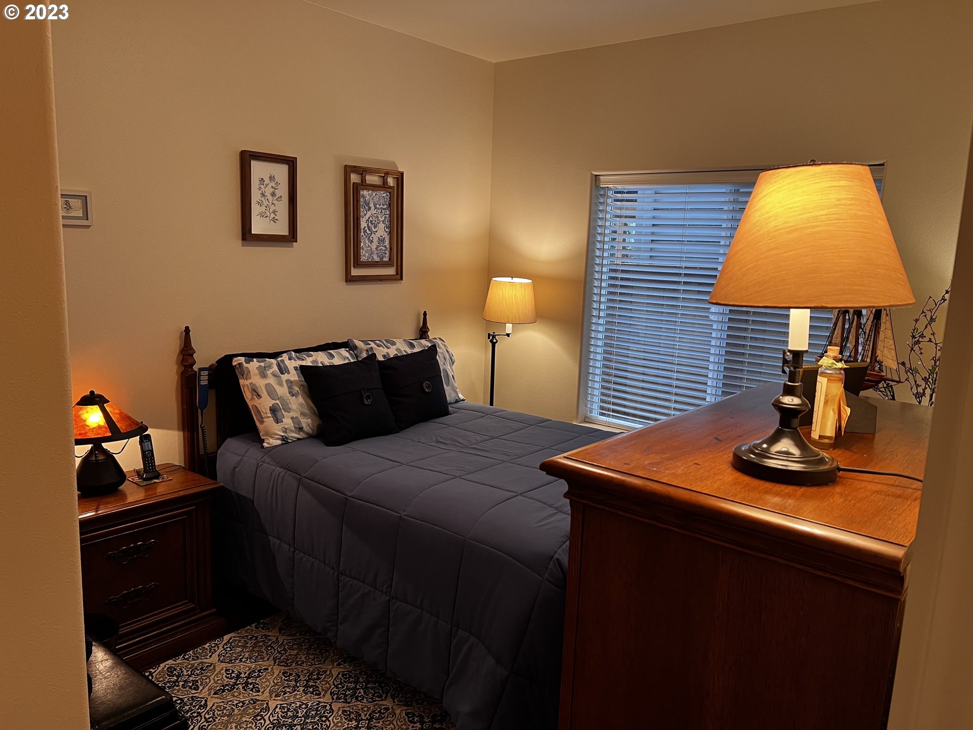 947 67th Place Springfield, OR 97478 - Photo 21 of 32 a bedroom with bed and a lamp on table