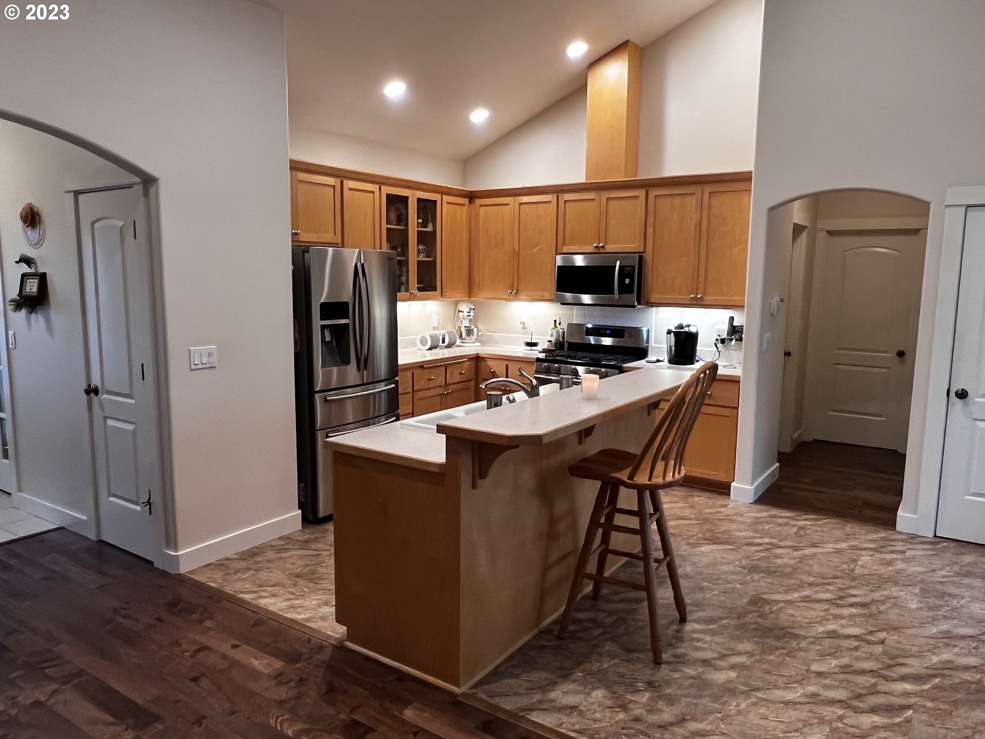 947 67th Place Springfield, OR 97478 - Photo 5 of 32 a kitchen with a refrigerator a sink and cabinets