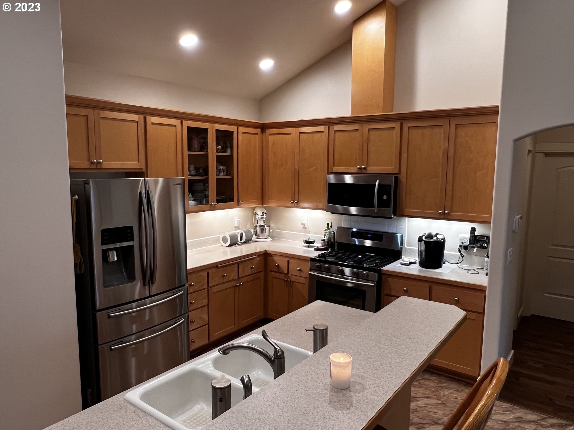 947 67th Place Springfield, OR 97478 - Photo 6 of 32 a kitchen with stainless steel appliances granite countertop a refrigerator a sink dishwasher a stove and a refrigerator with wooden floor