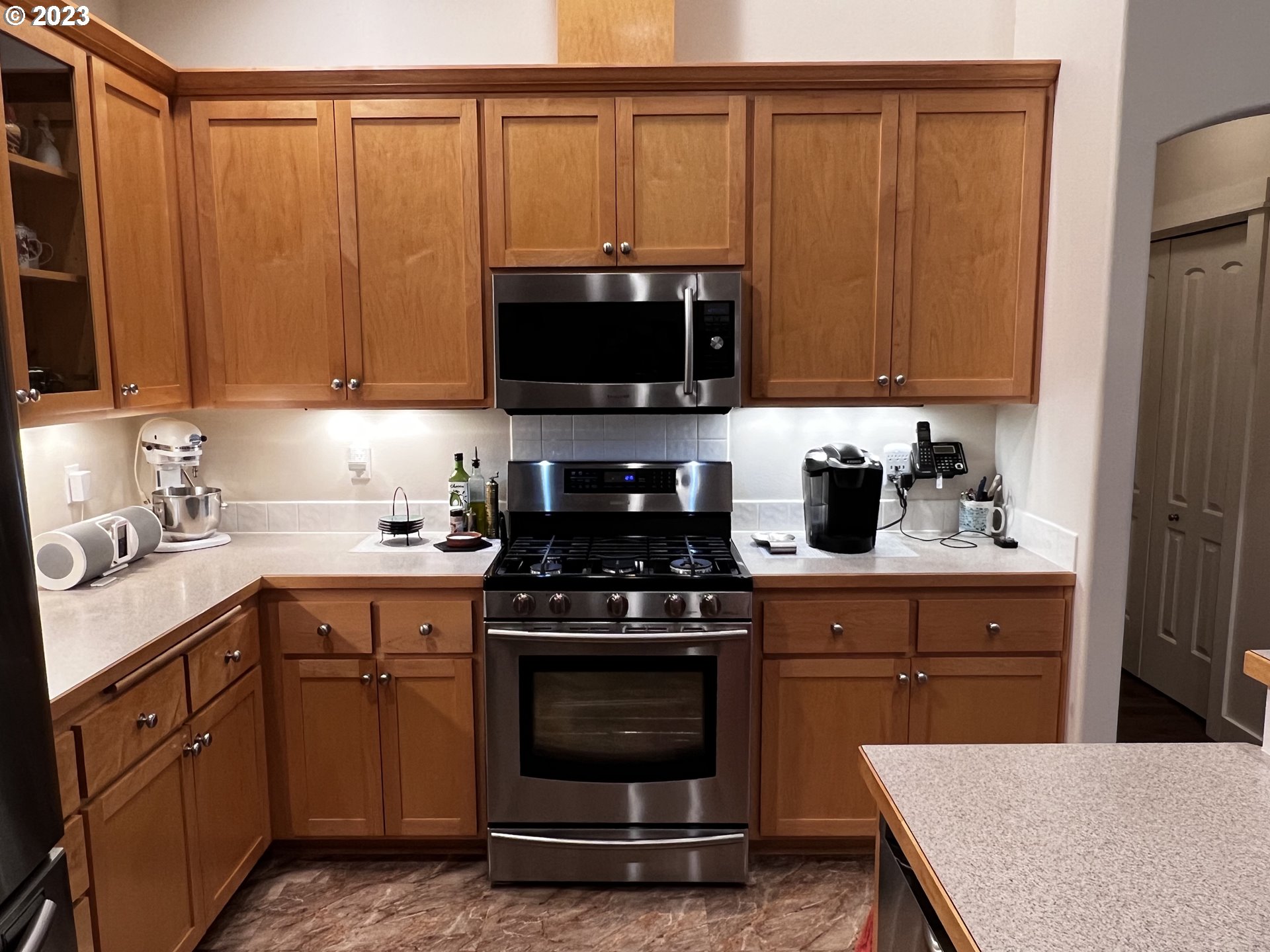 947 67th Place Springfield, OR 97478 - Photo 7 of 32 a kitchen with stainless steel appliances a stove a sink and a microwave