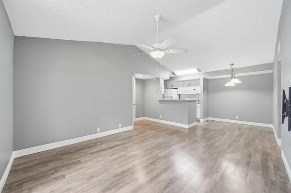 a view of a kitchen with a sink and a refrigerator