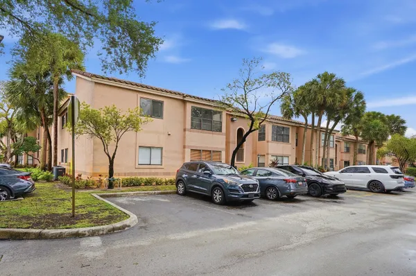 a city street with cars parked in front of it