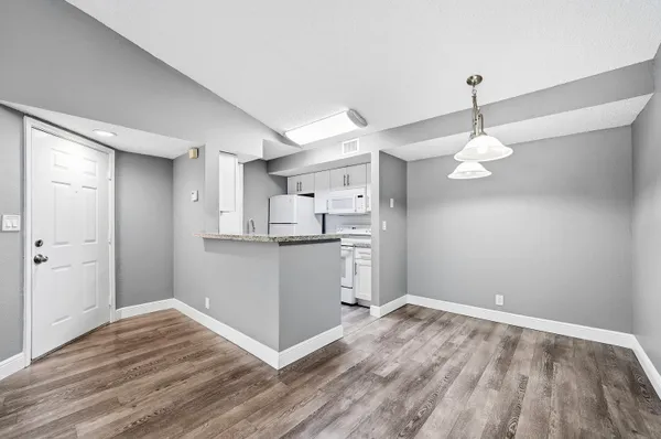 a view of a kitchen with wooden floor