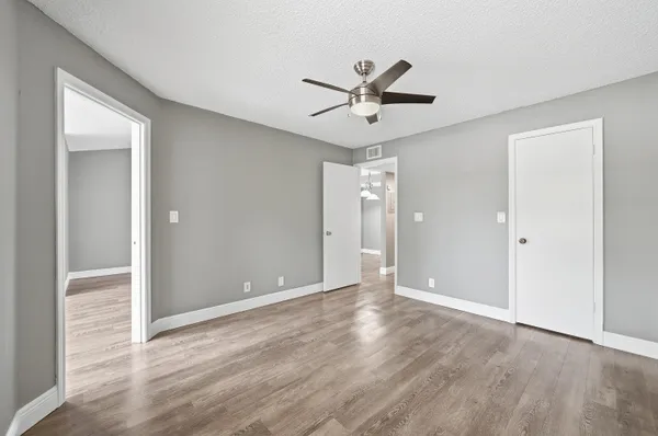 a view of an empty room and wooden floor