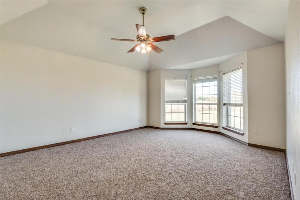 2072 Marshall Road Waxahachie, TX 75167 - Photo 7 of 14 an empty room with chandelier fan and windows