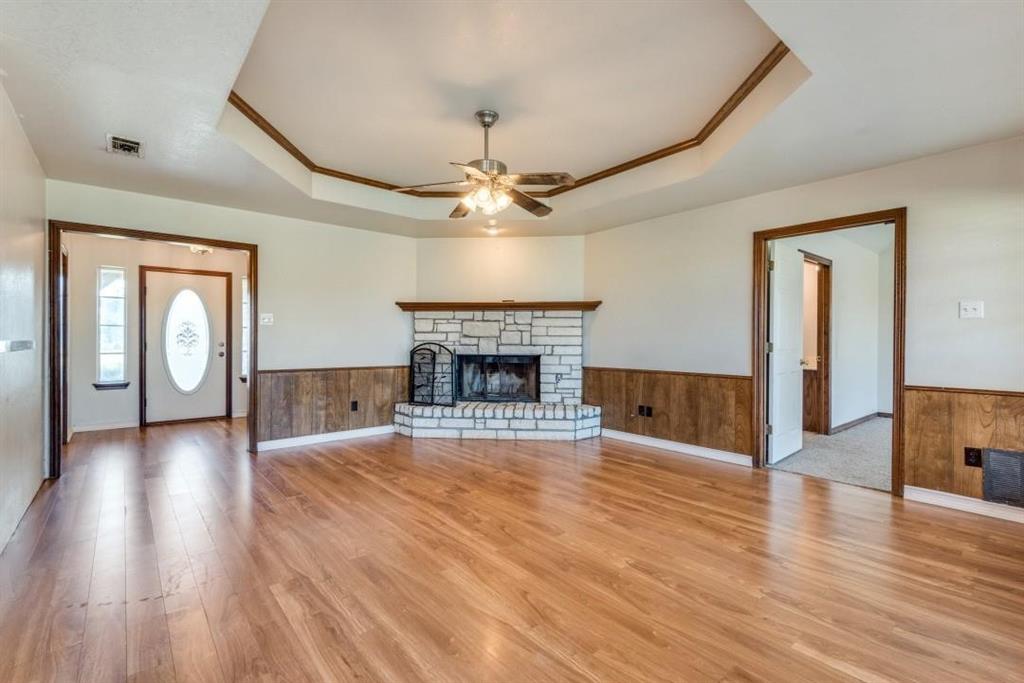 2072 Marshall Road Waxahachie, TX 75167 - Photo 9 of 14 a view of a livingroom with wooden floor a fireplace and window