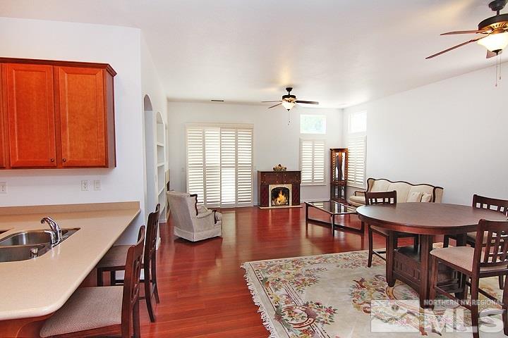 450 Manciano Way Reno, NV 89521 - Photo 11 of 39 a view of a a dining room with furniture window and wooden floor