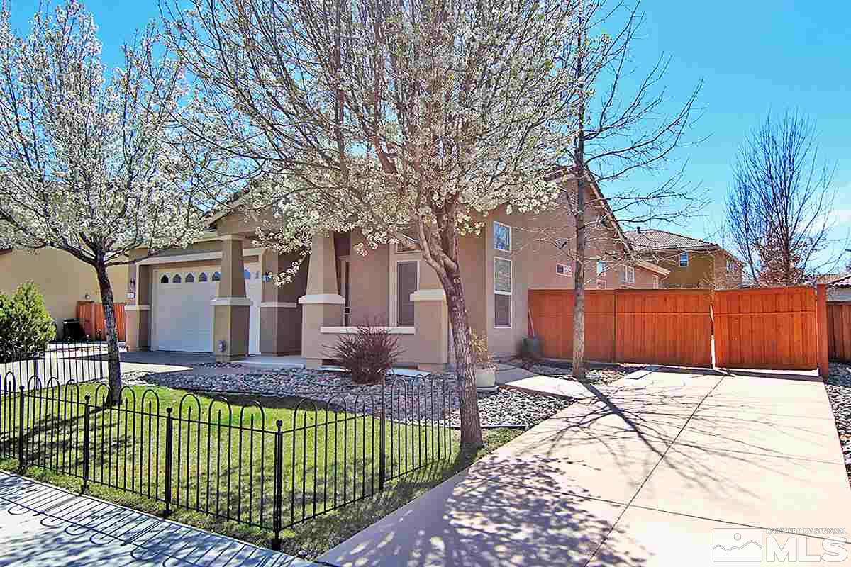 450 Manciano Way Reno, NV 89521 - Photo 2 of 39 a view of a house with a small yard and wooden fence