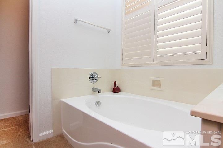 450 Manciano Way Reno, NV 89521 - Photo 25 of 39 a bathroom with bathtub and window