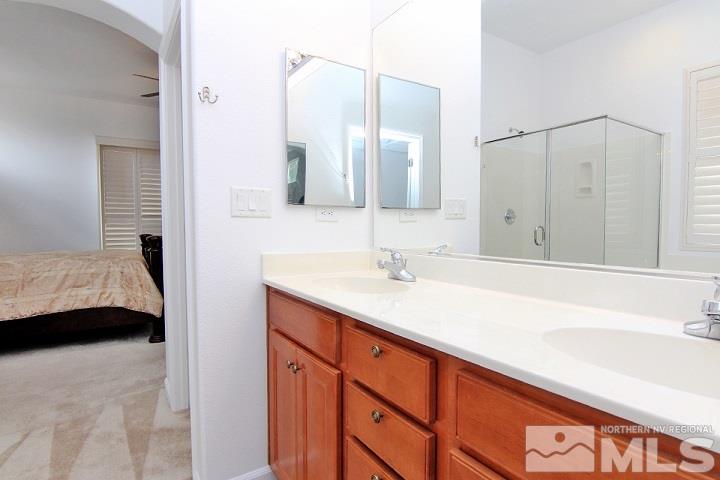450 Manciano Way Reno, NV 89521 - Photo 26 of 39 a en suite bathroom with a sink and a mirror