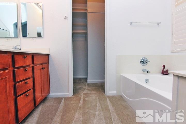 450 Manciano Way Reno, NV 89521 - Photo 29 of 39 a bathroom with a tub sink and mirror